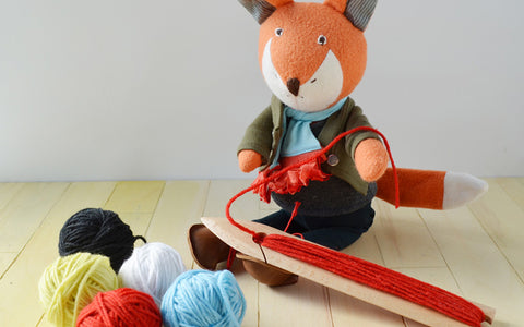 Owen Fox with Loom Practicing Weaving Pattern