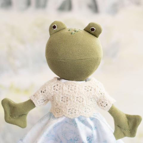 portrait of ella toad wearing snowflake sweater over swirling snow dress