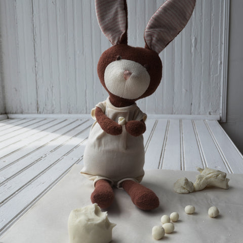 Juliette Rabbit rolls clay into bead shapes