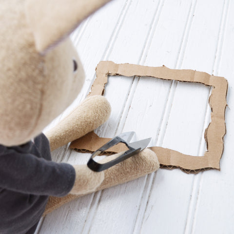 Juliette Rabbit cuts cardboard for picture frames