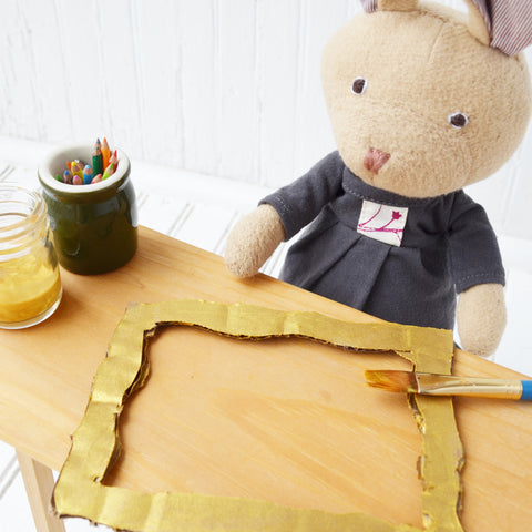 Juliette Rabbit cuts cardboard for picture frames