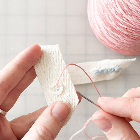 sewing the button onto the sash