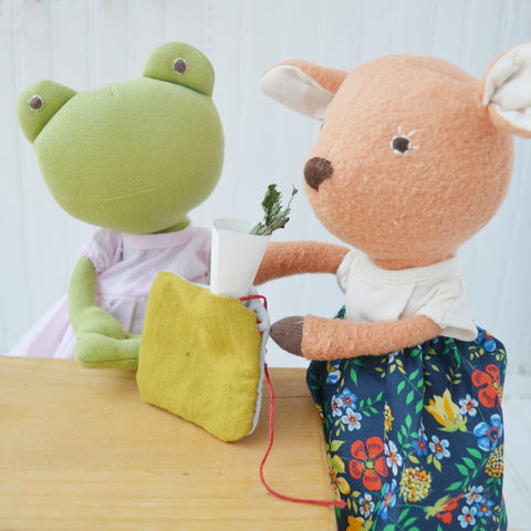Ella Toad and Phoebe Fawn funneling the herbs into the pillow