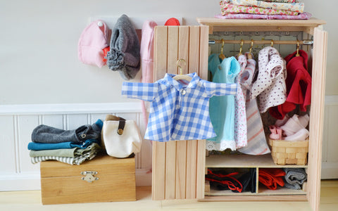 Blue checkered shirt on wooden hanger in room
